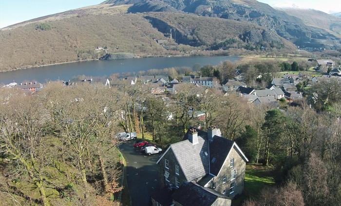 Bryn Du Mountain Centre drone photo, car park, woodland, Llanberis Village, Llyn Padarn Lake, Slate Quarry and Mountain View
